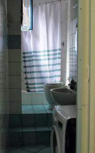a bathroom with a sink and a toilet and a shower at Casa Del Monte in Naples
