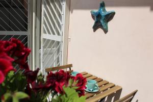 a table with a starfish hanging on the wall at Casa Del Monte in Naples