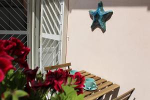 a table with a starfish hanging on the wall at Casa Del Monte in Naples +2 photos