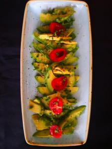 a white plate of vegetables with tomatoes on top at Salotto Brè - Bed & Breakfast charming rooms in Lugano +39 photos