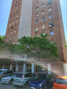 a tall building with cars parked in front of it at Grandera Apart`s - Sollana 18 in Valencia