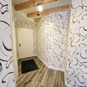 a room with a door and a wall covered in wallpaper at DM Hotels & Apartments - Apartment Rasenweg in Dingelstädt +83 photos
