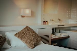 a hotel room with a bed and a counter with a sink at Hôtel Briketenia in Guéthary +34 photos