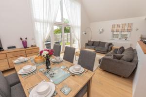 a living room with a dining table and a couch at The Sheiling in Woolacombe