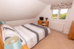 a bedroom with a bed and a window at The Sheiling in Woolacombe