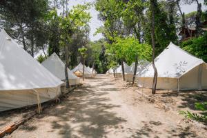 a row of tents in the middle of a dirt road at Camping Santa Elena in Lloret de Mar