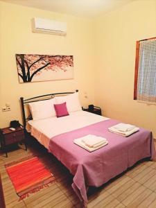 1 dormitorio con 1 cama con 2 toallas en Alba Traditional Countryhouse New Anchialos village, en Nea Anjíalos