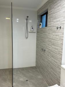 a shower with a glass door in a bathroom at Parkline Apartments Perth in Perth