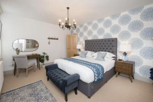 a bedroom with a bed and a chair and a mirror at Townhouse by Harrogate Serviced Apartments in Harrogate