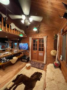 a living room with wooden walls and a ceiling at ぜーんぶ貸切!! 大自然の森に佇む秘密の隠れ家で心と身体を解放する... in Yuzawa