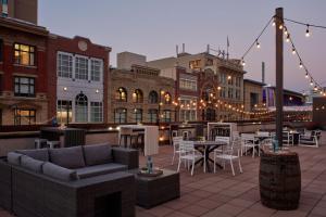 a rooftop patio with tables and chairs and lights at Calgary Marriott Downtown Hotel in Calgary