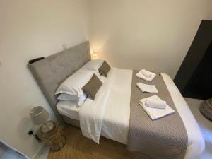 a bedroom with a large bed with white sheets and pillows at GaliniCafe22-suites in Kakopetria