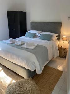 a large bed with two towels on it in a bedroom at GaliniCafe22-suites in Kakopetria