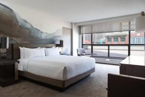 a hotel room with a bed and a large window at Calgary Marriott Downtown Hotel in Calgary