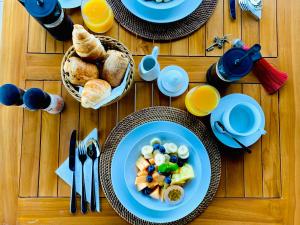 a table with plates of breakfast food on it at Chamarel Mountain chalets in Chamarel