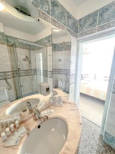 a bathroom with a large tub and a sink at Villa Nico in Zadar