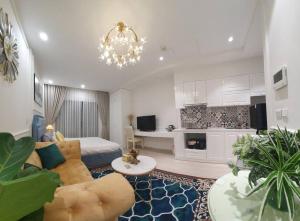 a large living room with a bed and a chandelier at Luxury econest - Apartment with swimming pool & gym in Hanoi