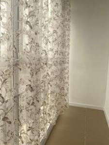 a room with a shower curtain and a wall at Жк Абырой Ризеденс in Atyrau