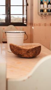a piece of bread sitting on a counter next to a bucket at The Blue House Valley in Grândola