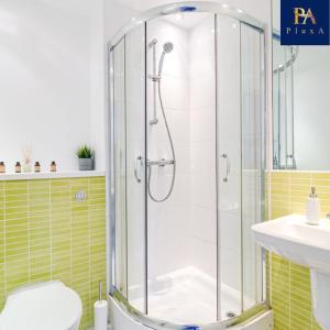 a bathroom with a shower with a toilet and a sink at Pluxa Waterside Apartment - Stylish 2bathrooms, walk to transit in Birmingham