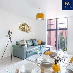 a living room with a couch and a glass table at Pluxa Waterside Apartment - Stylish 2bathrooms, walk to transit in Birmingham