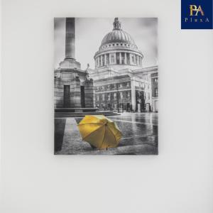 a yellow umbrella in the rain in front of a building at Pluxa Waterside Apartment - Stylish 2bathrooms, walk to transit in Birmingham
