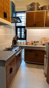 a kitchen with wooden cabinets and a counter top at Hibiscus Apartments in Dhaka