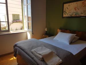 a bedroom with a bed and two windows at Ines Guest House in North Nicosia