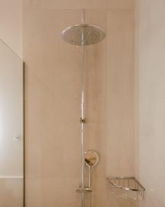 a shower with a glass door and a shower head at Eterrano Seaside Retreat in Parga
