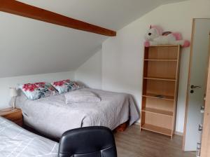 1 dormitorio con 1 cama y 1 silla en Les Clés de XOULCES, en Cornimont