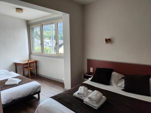 Postel nebo postele na pokoji v ubytování Hotel Au Val Doré