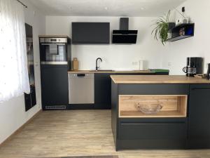 a kitchen with black and white appliances and a counter at Traunwald in Grassach
