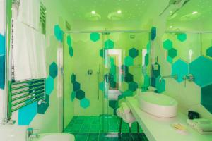 a bathroom with a tub and a sink and a toilet at Villa Nettuno in Positano