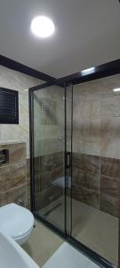 a bathroom with a glass shower with a toilet at LAOS OTEL in Istanbul