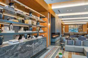 a lobby with a couch and chairs and a fireplace at AC Hotel by Marriott Washington DC Convention Center in Washington