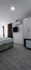 a bedroom with a bed and a tv in it at LAOS OTEL in Istanbul