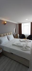 a large white bed in a room with at LAOS OTEL in Istanbul