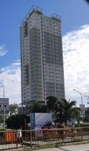 a large tall building in the middle of a city at Sunvida Tower Condominium across SM Cebu City in Cebu City