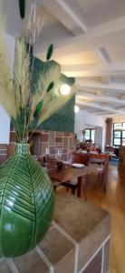 a large green vase sitting on top of a table at Auberge De La Gaichel in Gaichel