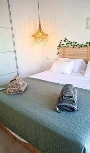 a bedroom with two beds with towels on the bed at Casa-Mar Nerja in Nerja