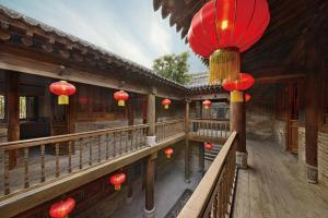 a balcony of a building with red lanterns on it at One Meter Sunshine Xi'an Xianyang International Airport Hotel in Xianyang