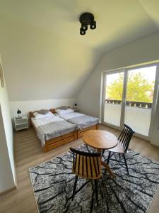 a bedroom with a bed and a table and chairs at Nad Doliną Krutyni in Ukta