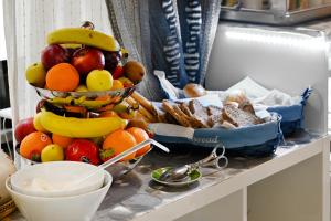 a pile of fruit and bread on a counter at Notti A Roma in Rome