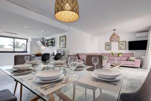een eetkamer en een woonkamer met een tafel en stoelen bij 4 Bedroom Townhouse 200 meters from the Beach! in Estepona