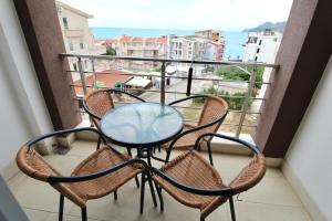 a table and chairs on a balcony with a view at 1bd Sea View Apts Veliki Pjesak "Mula" in Dobra Voda
