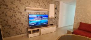 a living room with a flat screen tv on a wall at Espacioso Arrissala in Nador