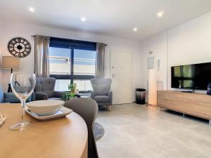 a living room with a television and a dining table at Levansur Apartment - 9109 in San Pedro del Pinatar