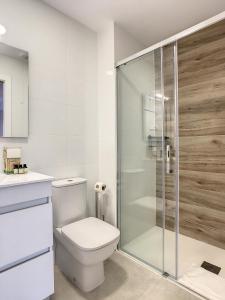 a bathroom with a toilet and a glass shower at Levansur Apartment - 9109 in San Pedro del Pinatar