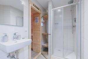 a bathroom with a shower and a sink and a toilet at Chalet Badia by we rent, SUMMERCARD INCLUDED in Zell am See