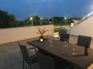 a table with wine glasses on top of a roof at 49 Laguna Beach in Torrevieja